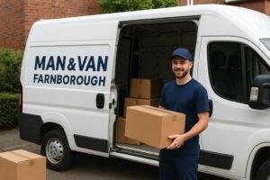 Man and Van Farnborough mover loading boxes into a white removal van outside a house